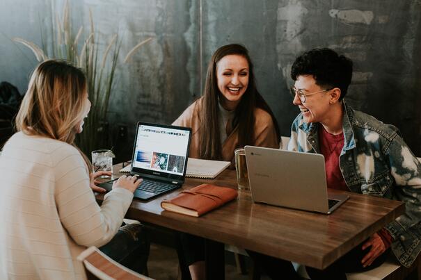 Young people sat at a desk